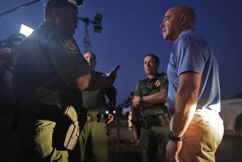 U.S. Homeland Security Secretary Alejandro Mayorkas listens to U.S. Border Patrol chief Raul Ortiz near the border with Mexico in La Joya on May 17, 2022.
