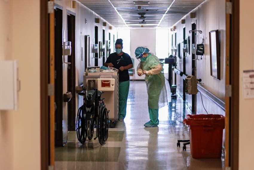 A nurse dons full PPE before entering the room of a COVID-19 patient at Goodall-Witcher Hospital in Clifton on Wednesday, August 3, 2021.